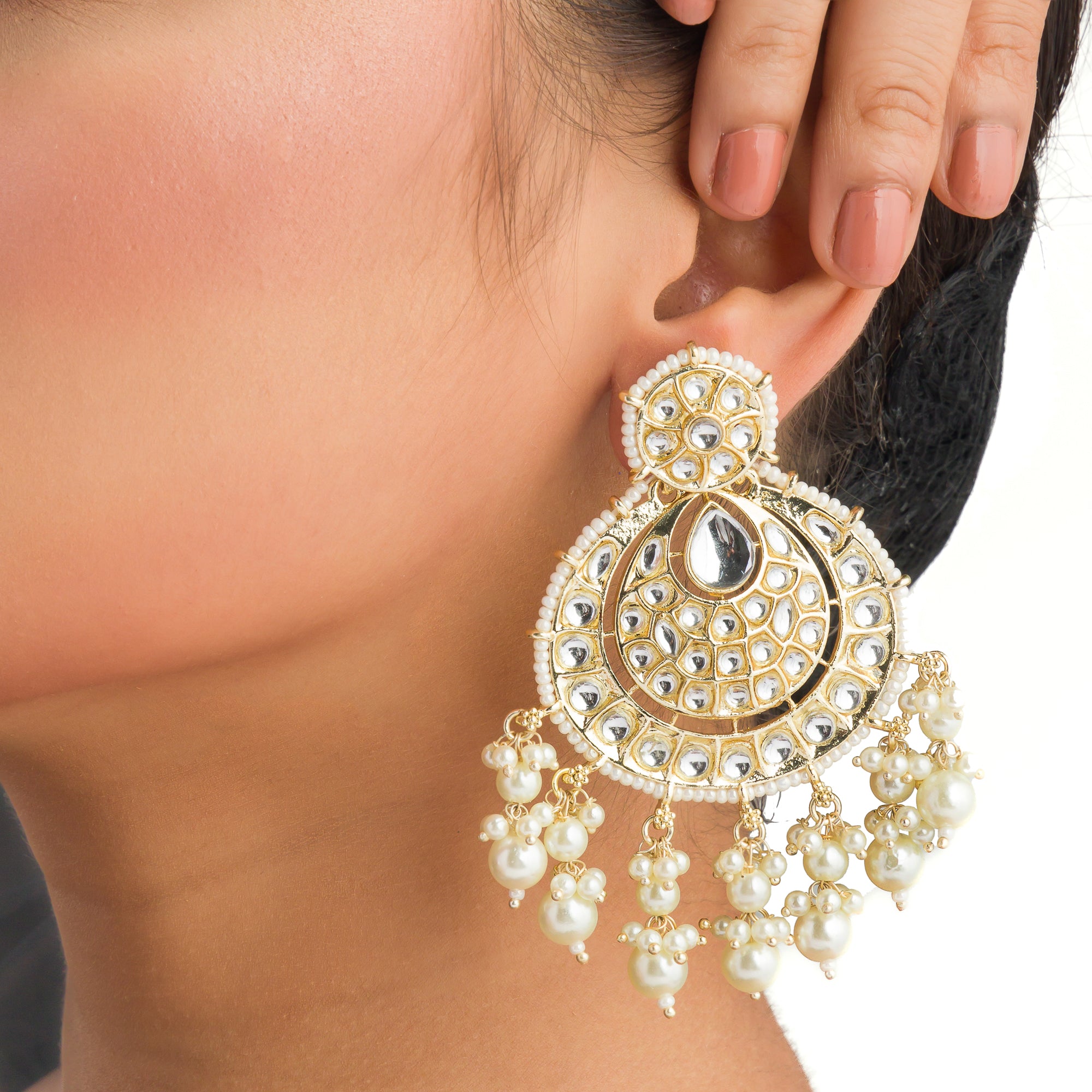 "Chandbali Kundan earrings with intricate design make a bold, regal statement."
