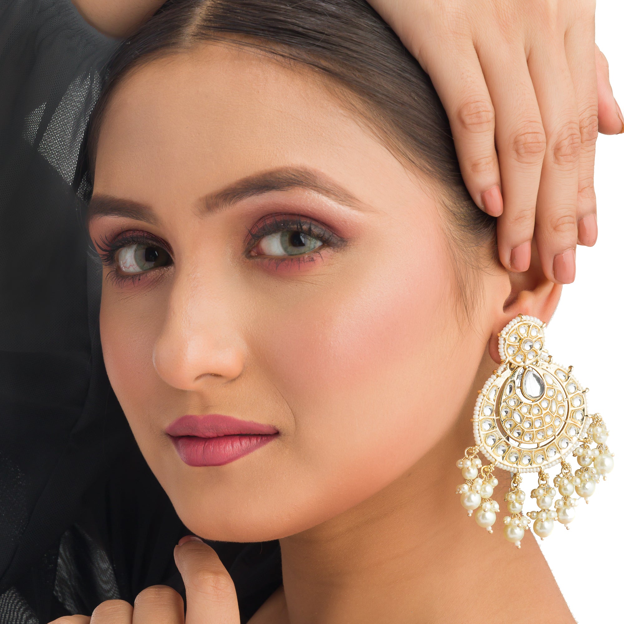 "Chandbali Kundan earrings with intricate design make a bold, regal statement."
