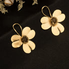 "Gold-tone flower studs with uncut stones offer timeless elegance for any occasion."

