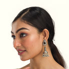 "Oxidized jhumka with black stone delivers a striking vintage allure for a timeless style."
