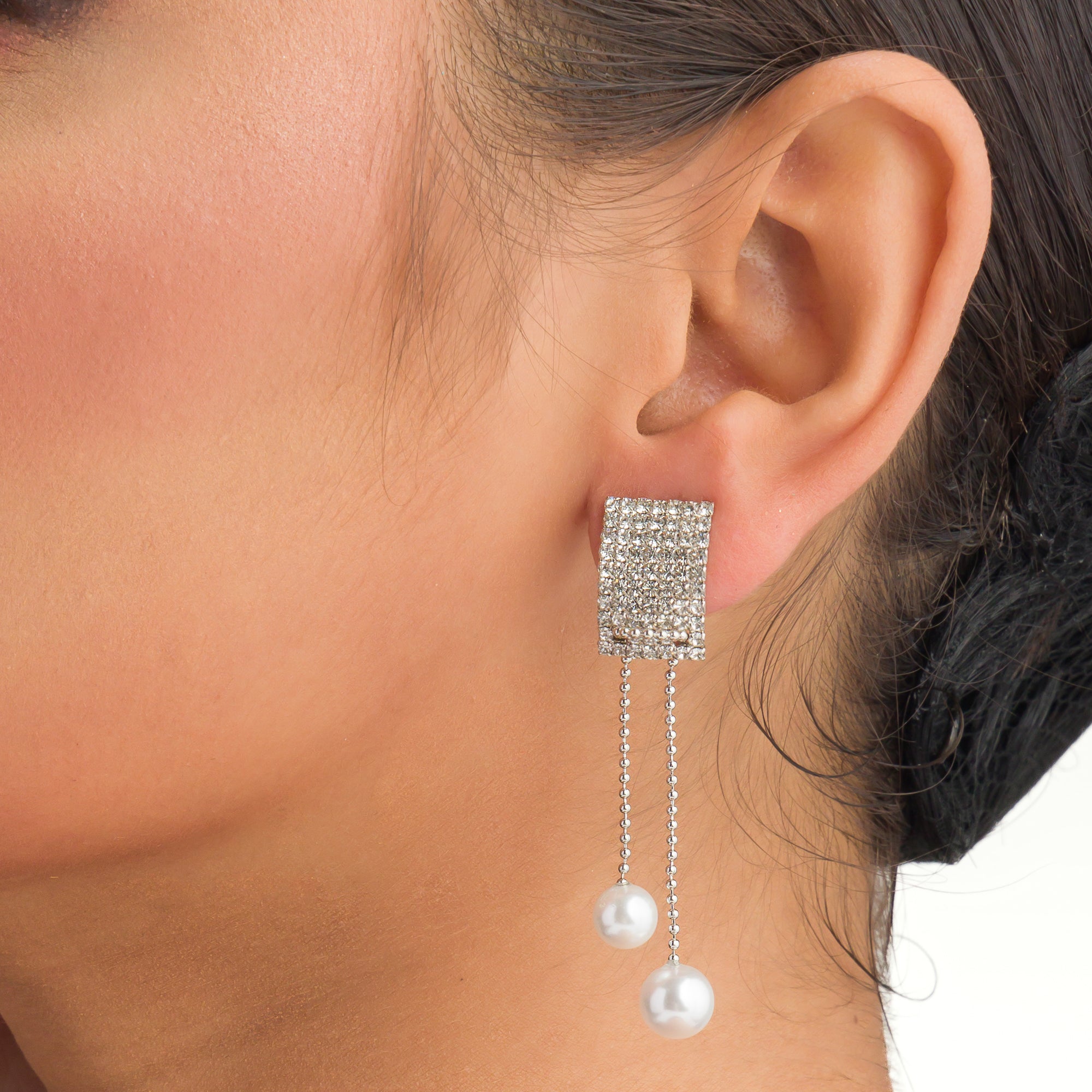 "Silver zircon earrings with hanging pearls offer elegant sparkle and sophistication."

