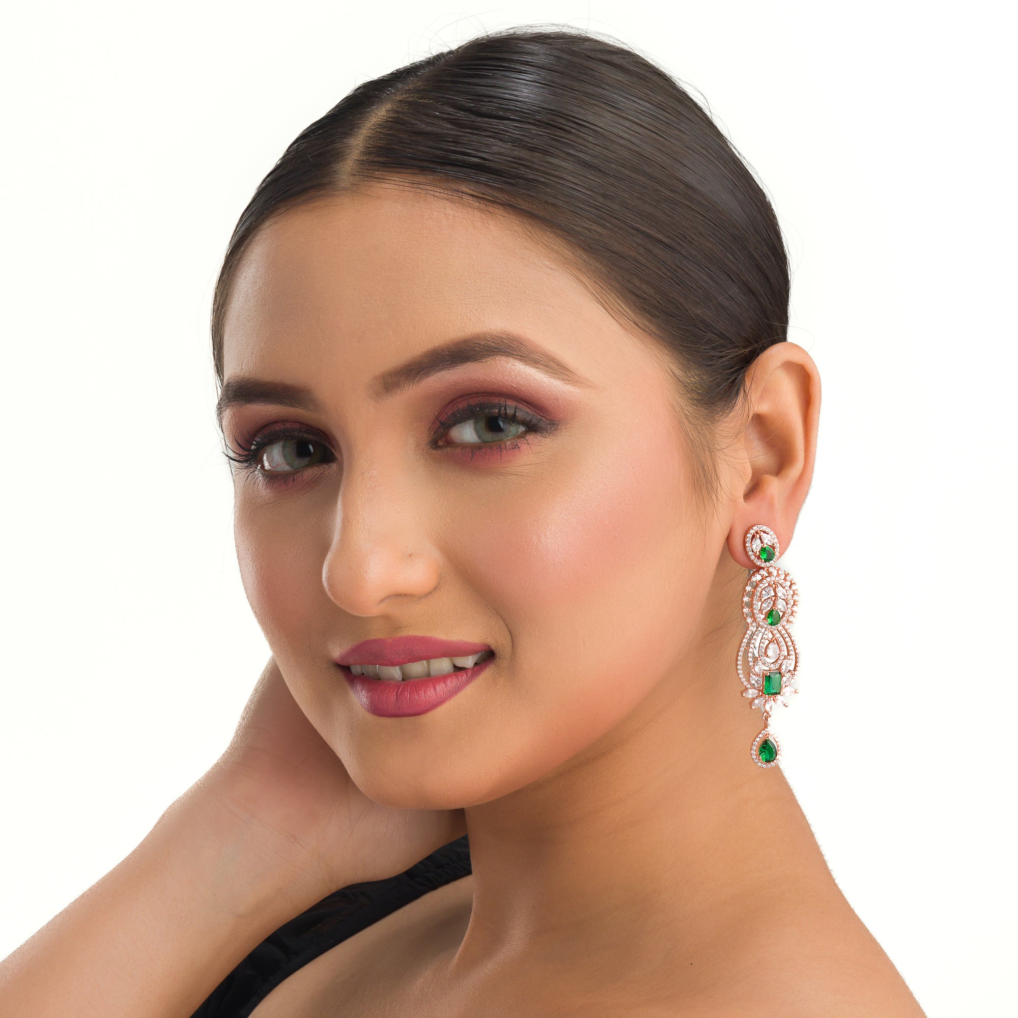 Green and white zircon earrings with rose gold polish exude vibrant elegance and style."
