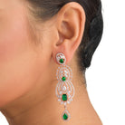 Green and white zircon earrings with rose gold polish exude vibrant elegance and style."
