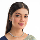 "Zircon silver necklace with pink and green accents adds a delicate, colorful touch."
