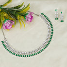 "Zircon necklace with white and green stones adds a vibrant, elegant touch."
