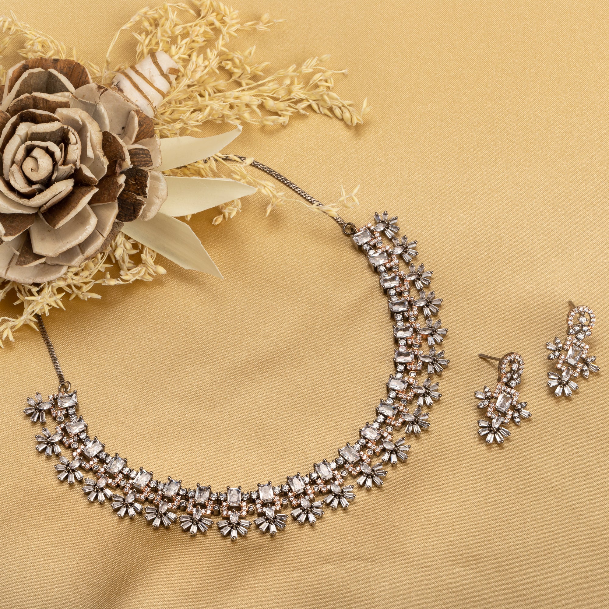 "Square and floral zircon necklace in rose gold blends geometric and floral elegance."
