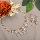 "Salmon zircon necklace with white zircons adds vibrant sparkle for a lively, chic look."
