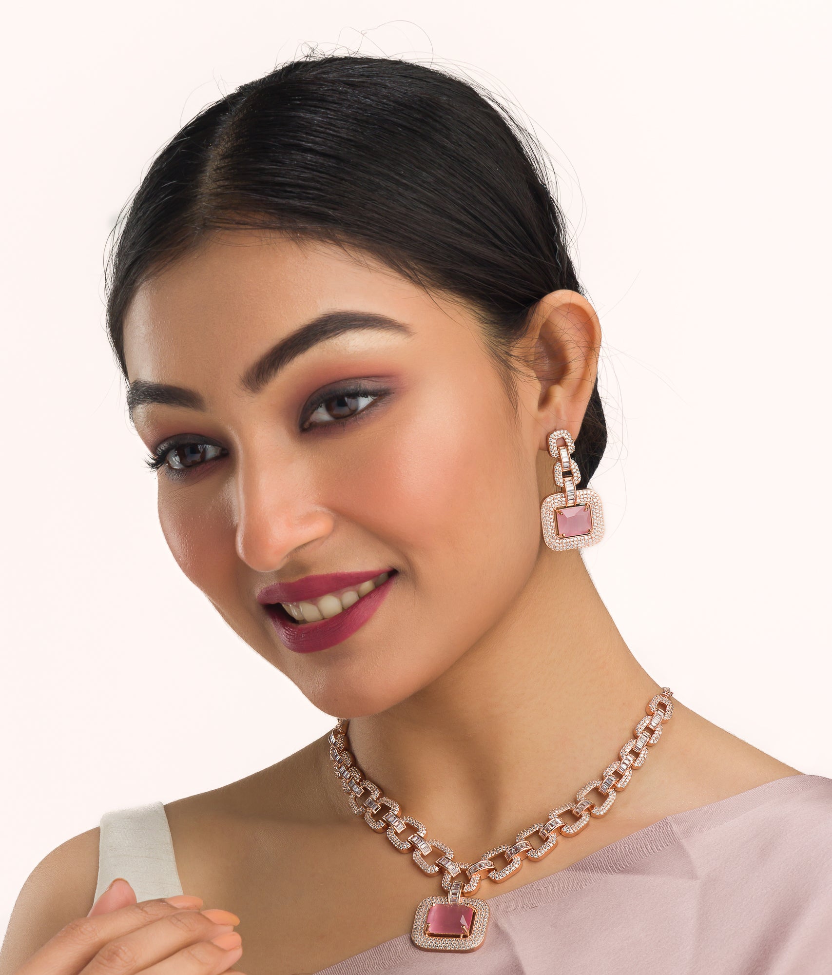 "Pink square and white zircon necklace with rose gold polish shines elegantly."
