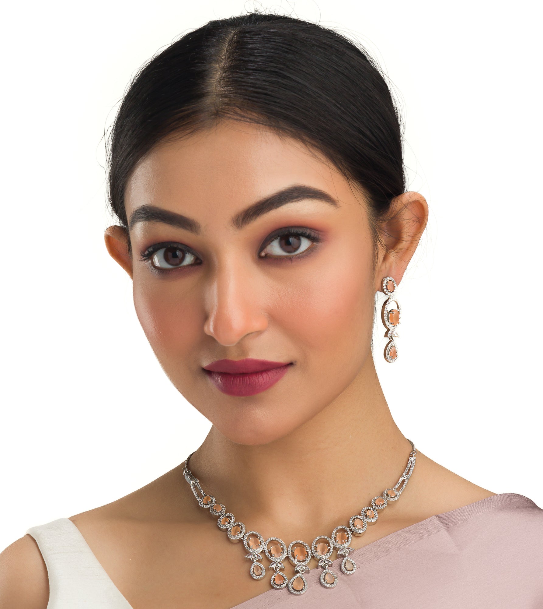 Salmon zircon necklace dazzles with its warm, unique glow for a stylish statement."
