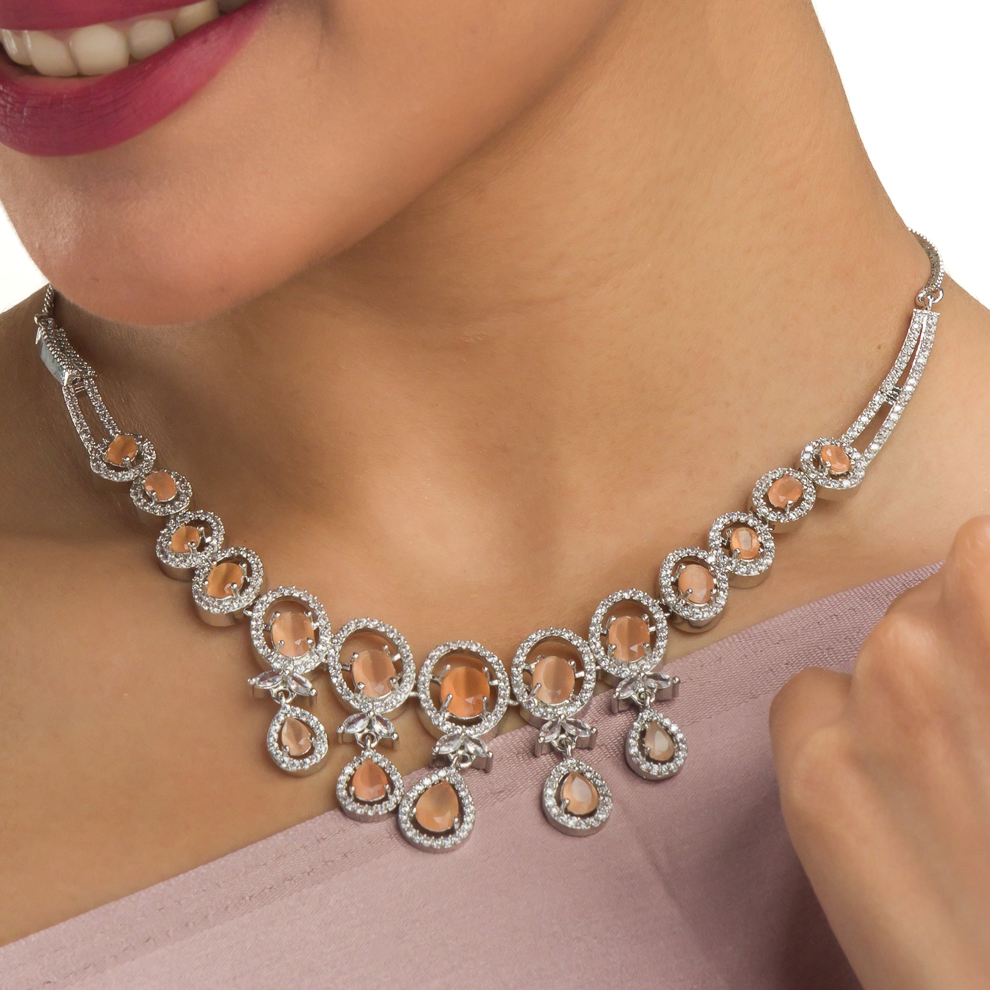 Salmon zircon necklace dazzles with its warm, unique glow for a stylish statement."

