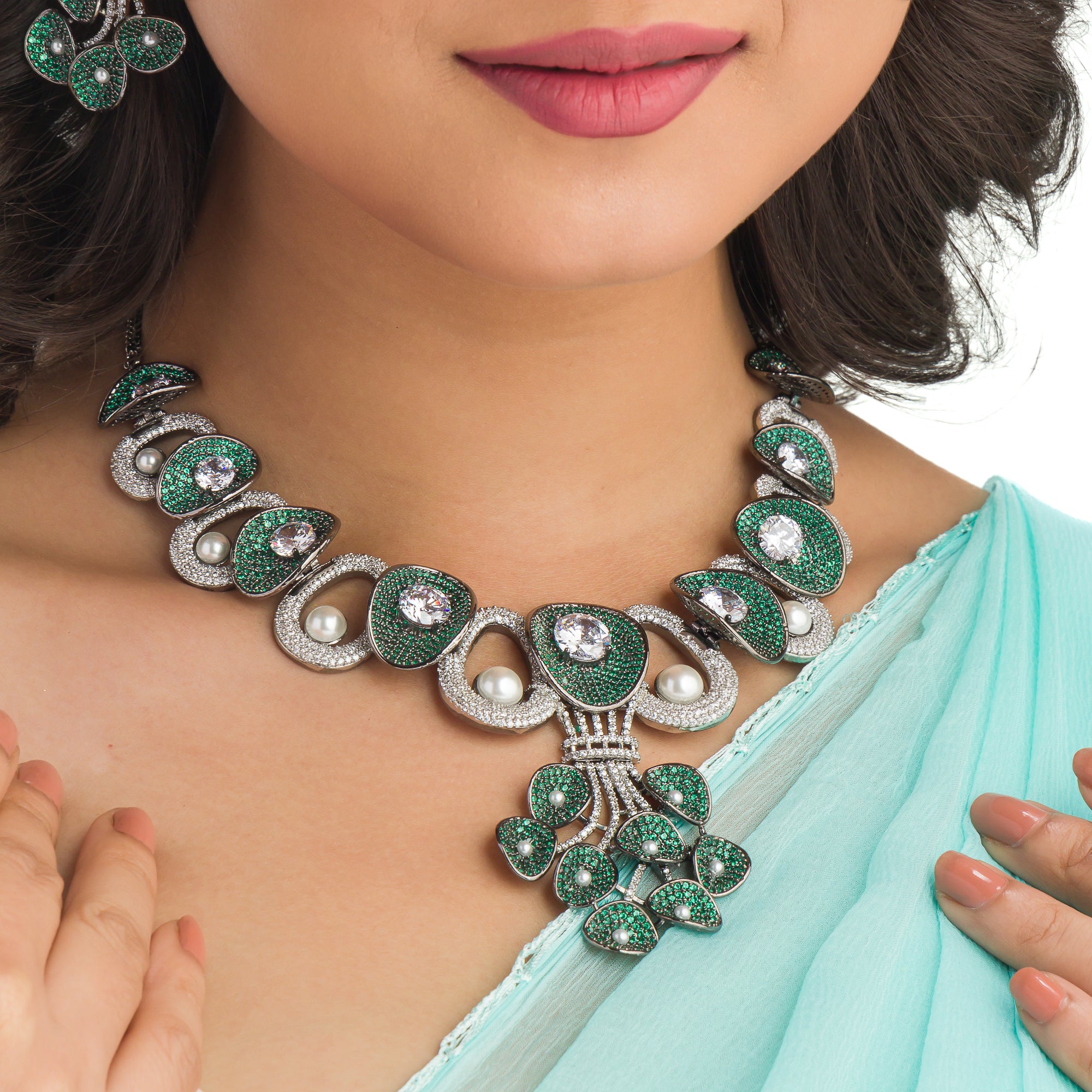Tree-shaped necklace with green and white zircons brings a unique, elegant charm to any party look.
