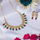 Elegant multicolor Kundan necklace with green and maroon stones for a regal, sophisticated party look.
