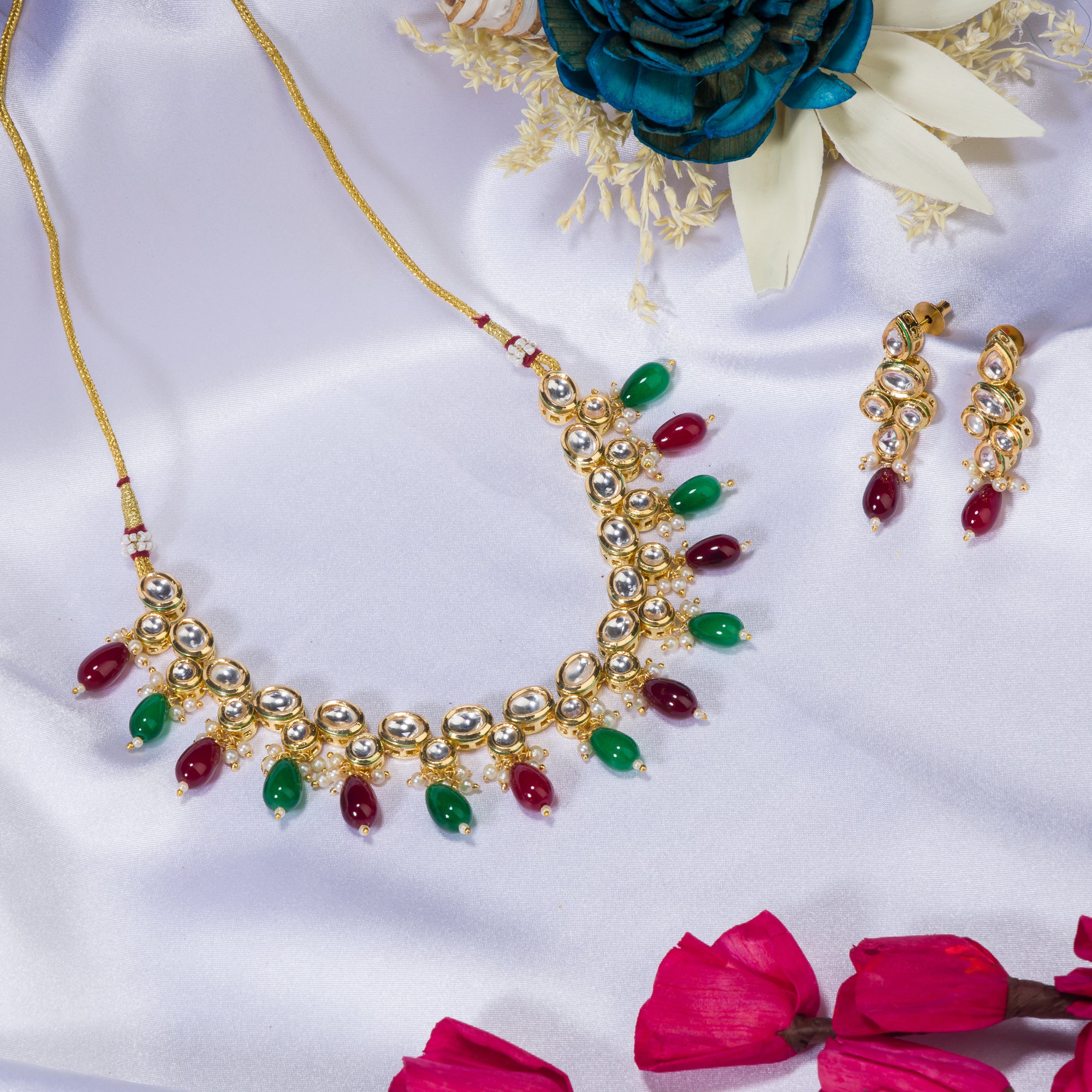 Elegant multicolor Kundan necklace with green and maroon stones for a regal, sophisticated party look.

