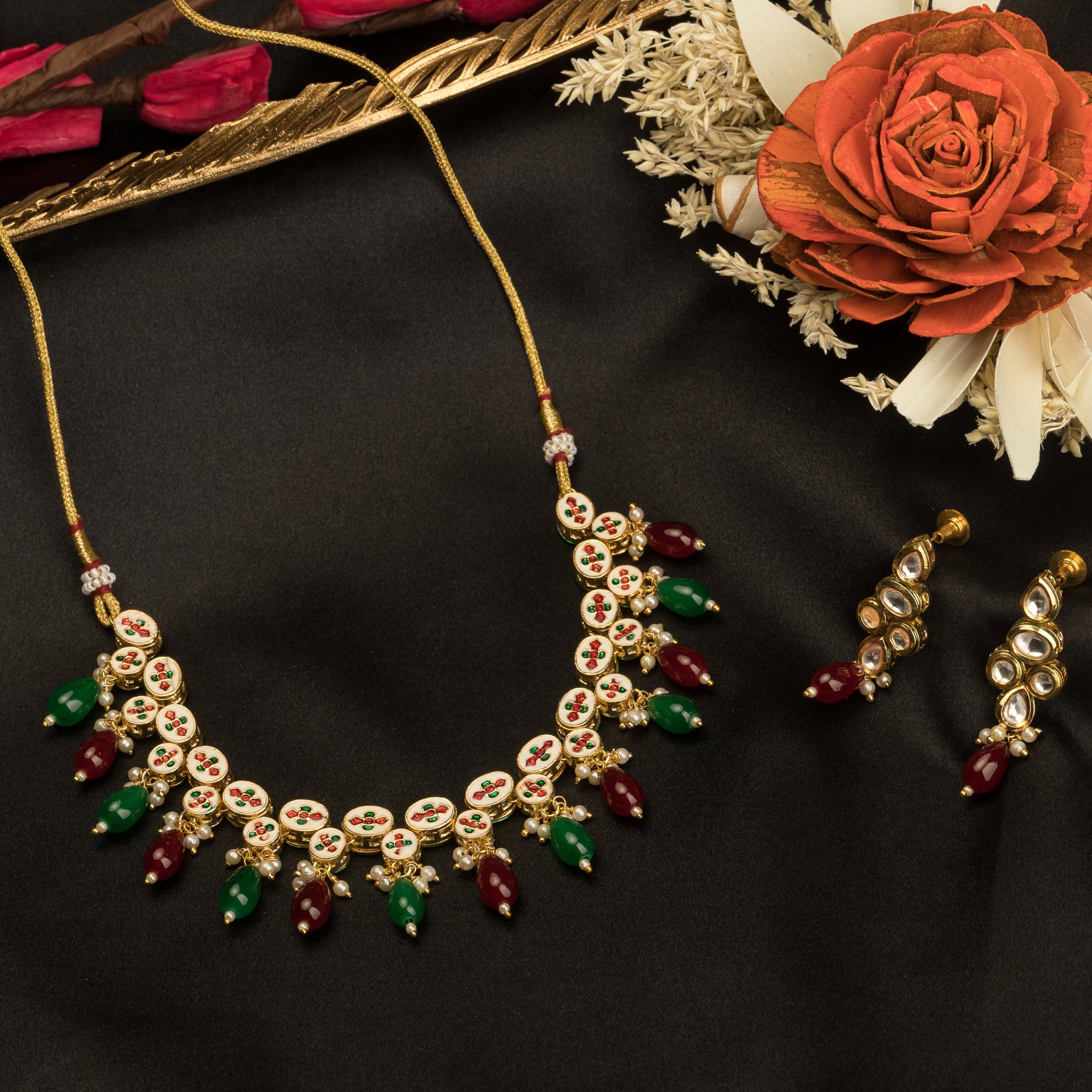 Elegant multicolor Kundan necklace with green and maroon stones for a regal, sophisticated party look.
