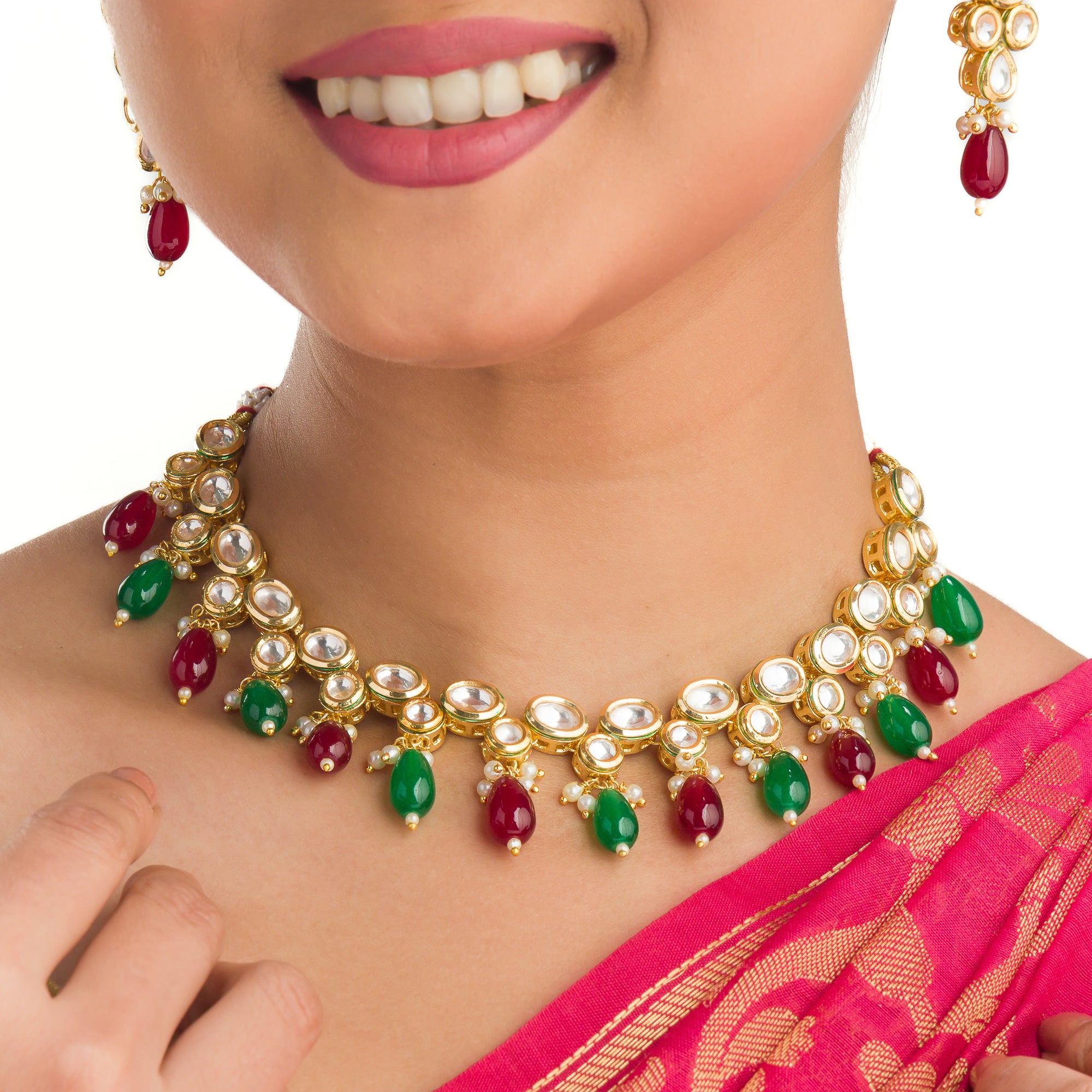 Elegant multicolor Kundan necklace with green and maroon stones for a regal, sophisticated party look.
