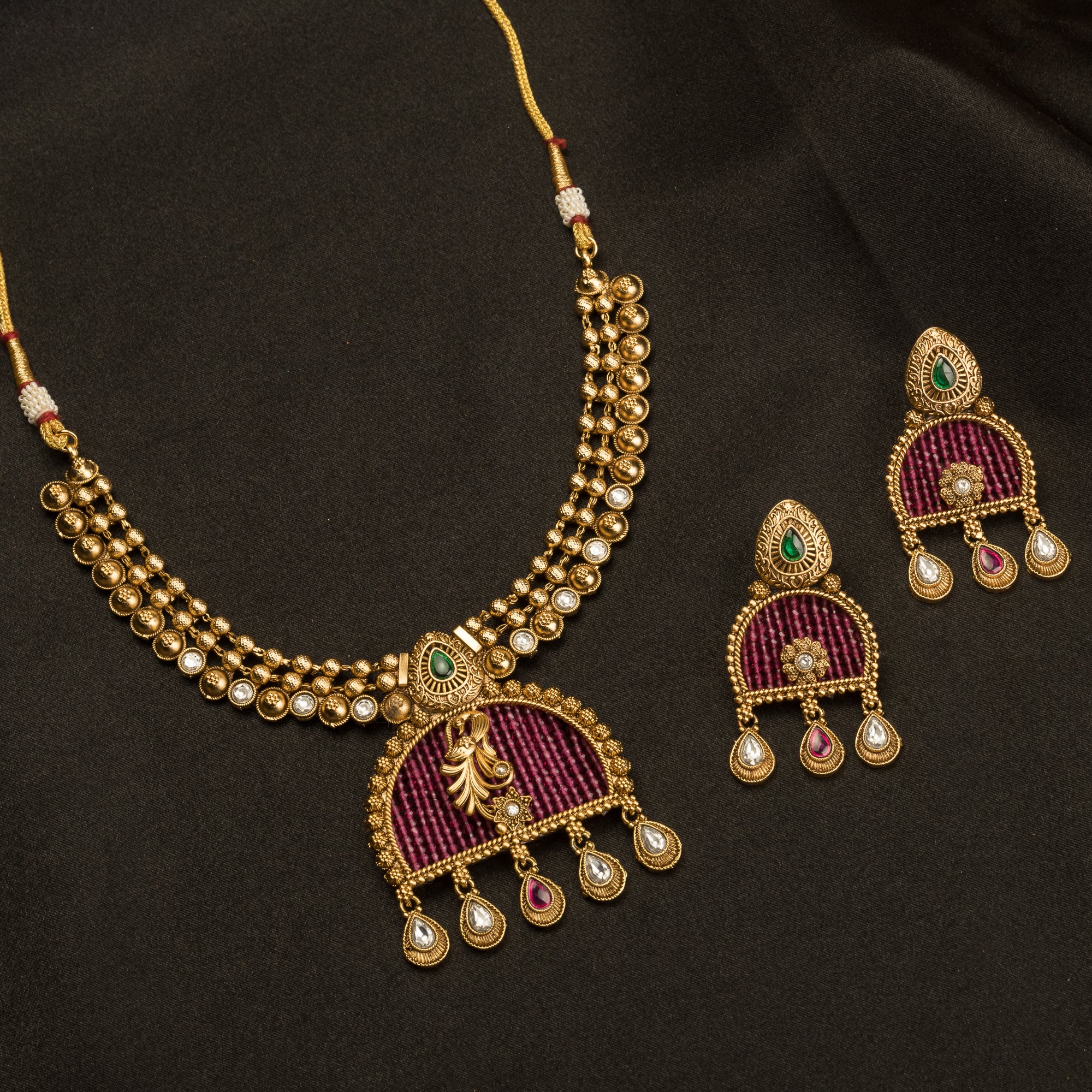 Elegant pink gold-tone short necklace exudes understated charm for a graceful festival look.
