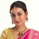 Elegant pink gold-tone short necklace exudes understated charm for a graceful festival look.
