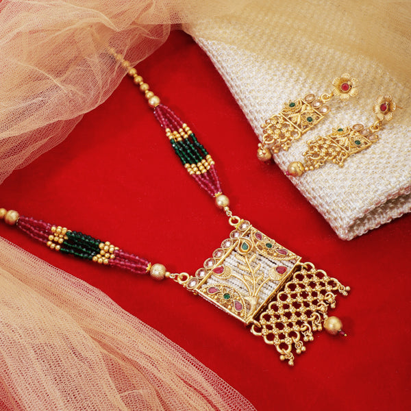 Vibrant gold long necklace with multicolor stones enhances festive attire with vibrant elegance
