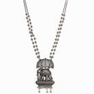 "Oxidized long necklace with umbrella, elephant motifs, and white pearls exudes vintage elegance."
