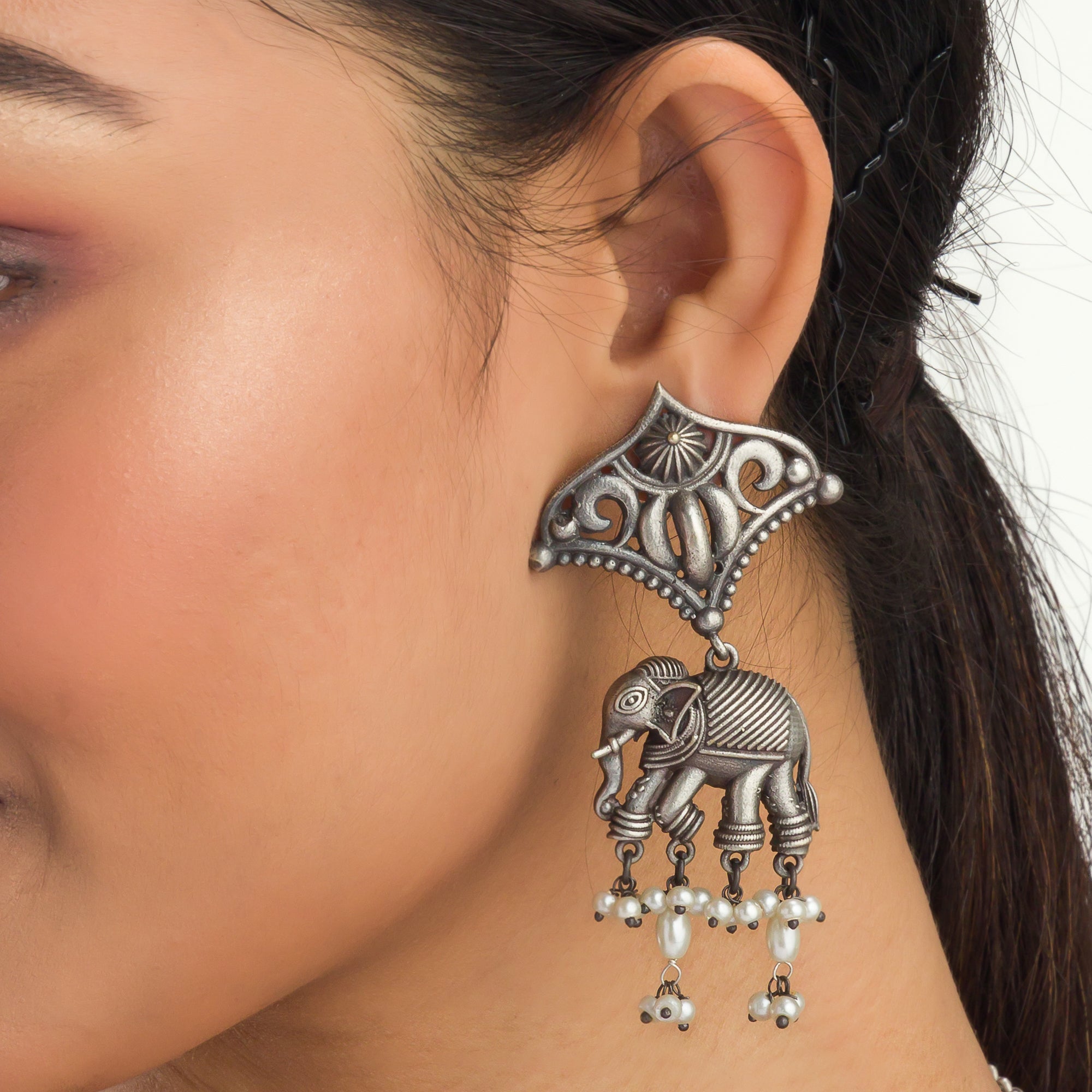 "Oxidized long necklace with umbrella, elephant motifs, and white pearls exudes vintage elegance."
