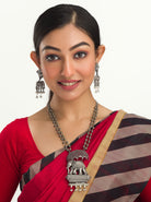"Oxidized long necklace with umbrella, elephant motifs, and white pearls exudes vintage elegance."
