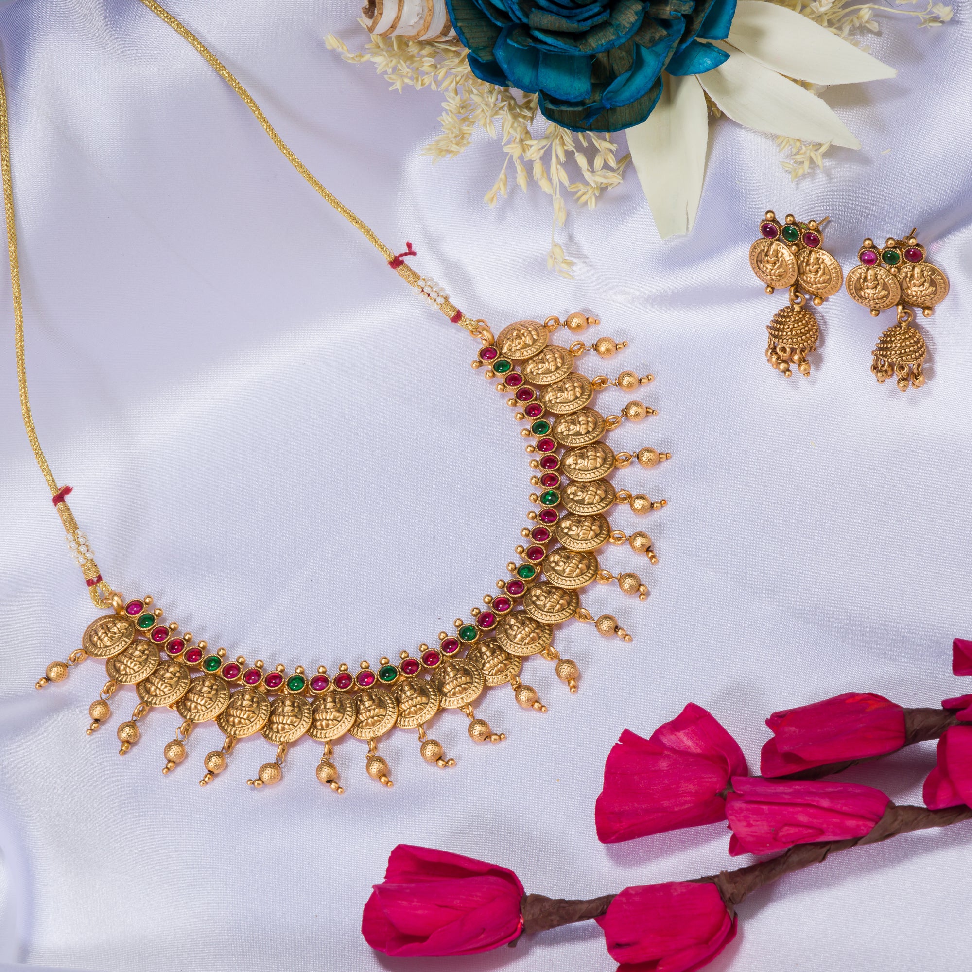 Coin-style gold-tone temple necklace exudes classic elegance and timeless tradition.
