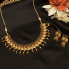 Coin-style gold-tone temple necklace exudes classic elegance and timeless tradition.
