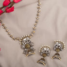 An oxidized dual-colour necklace with elephant and white pearls adds vintage charm and elegance.
