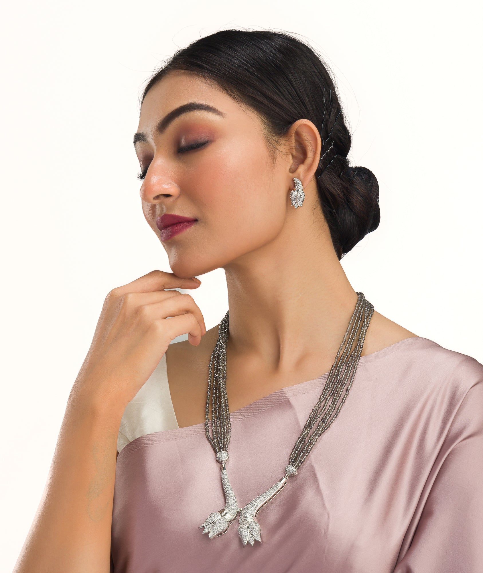 Trendy long grey zircon necklace with silver accents offers sleek, modern sophistication.
