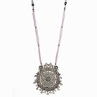 "Long oxidized necklace with pink and white pearls adds vintage elegance."
