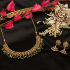 "Stylish gold-tone necklace with green Kundan for vibrant, elegant appeal."
