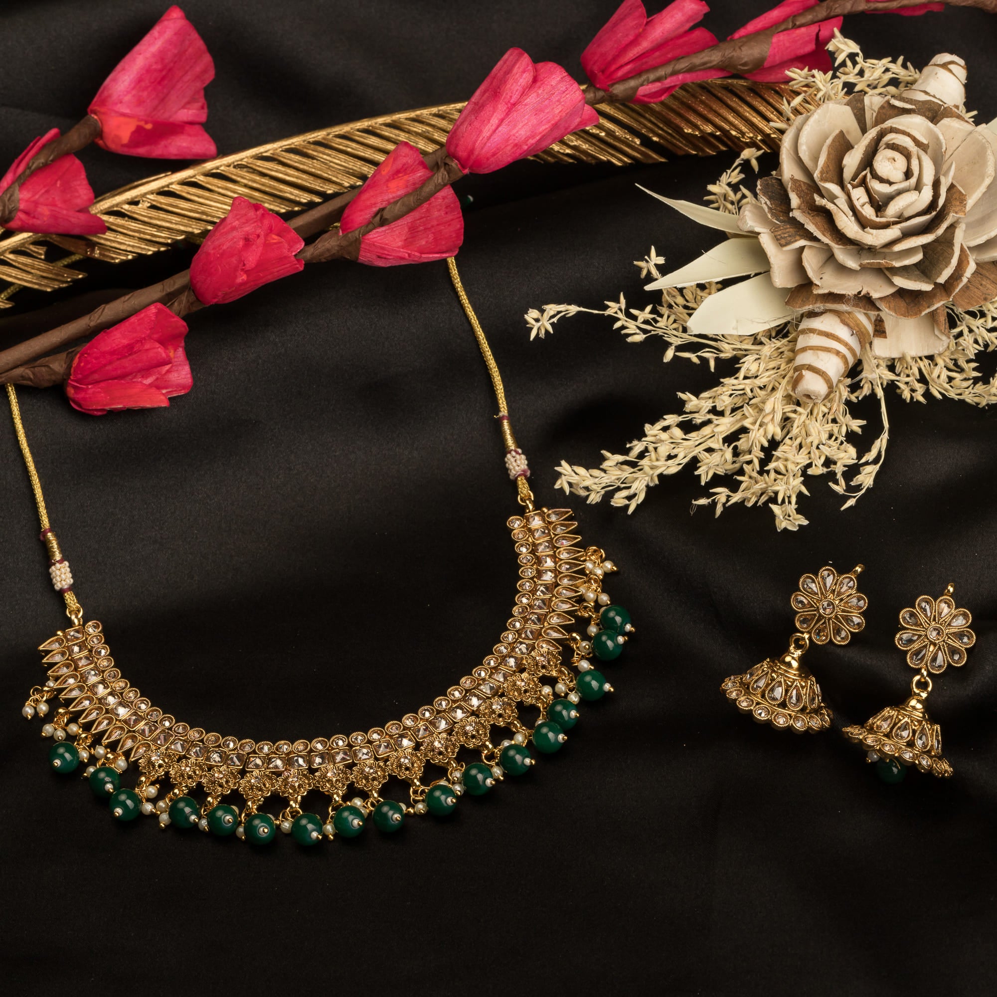 "Stylish gold-tone necklace with green Kundan for vibrant, elegant appeal."
