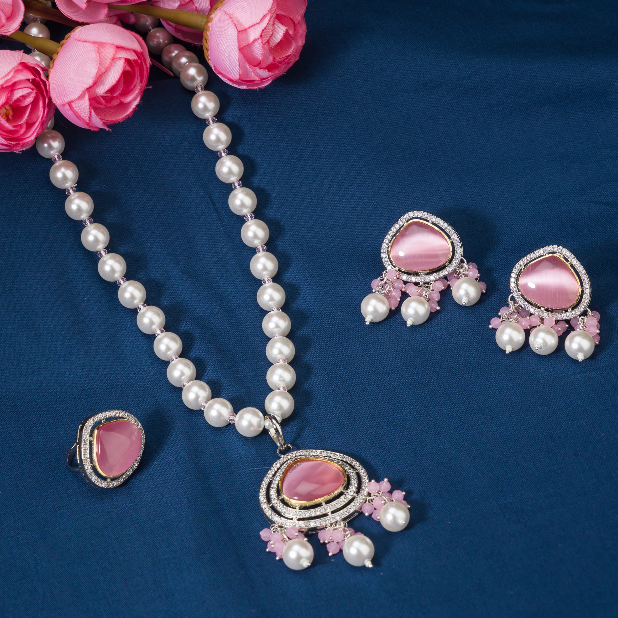 "Graceful pink pendant on a white pearl long necklace for a feminine touch."

