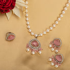 "Graceful pink pendant on a white pearl long necklace for a feminine touch."
