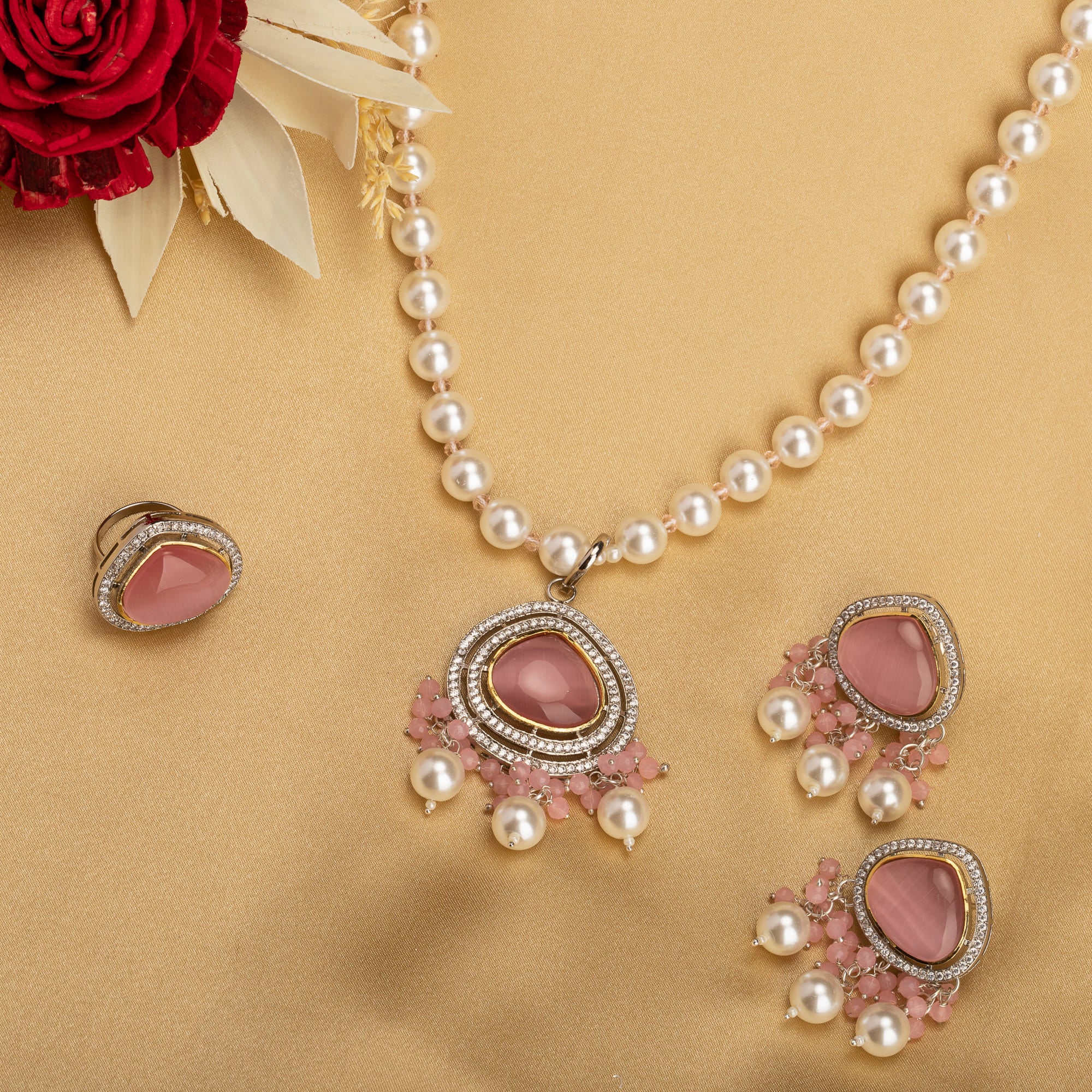 "Graceful pink pendant on a white pearl long necklace for a feminine touch."
