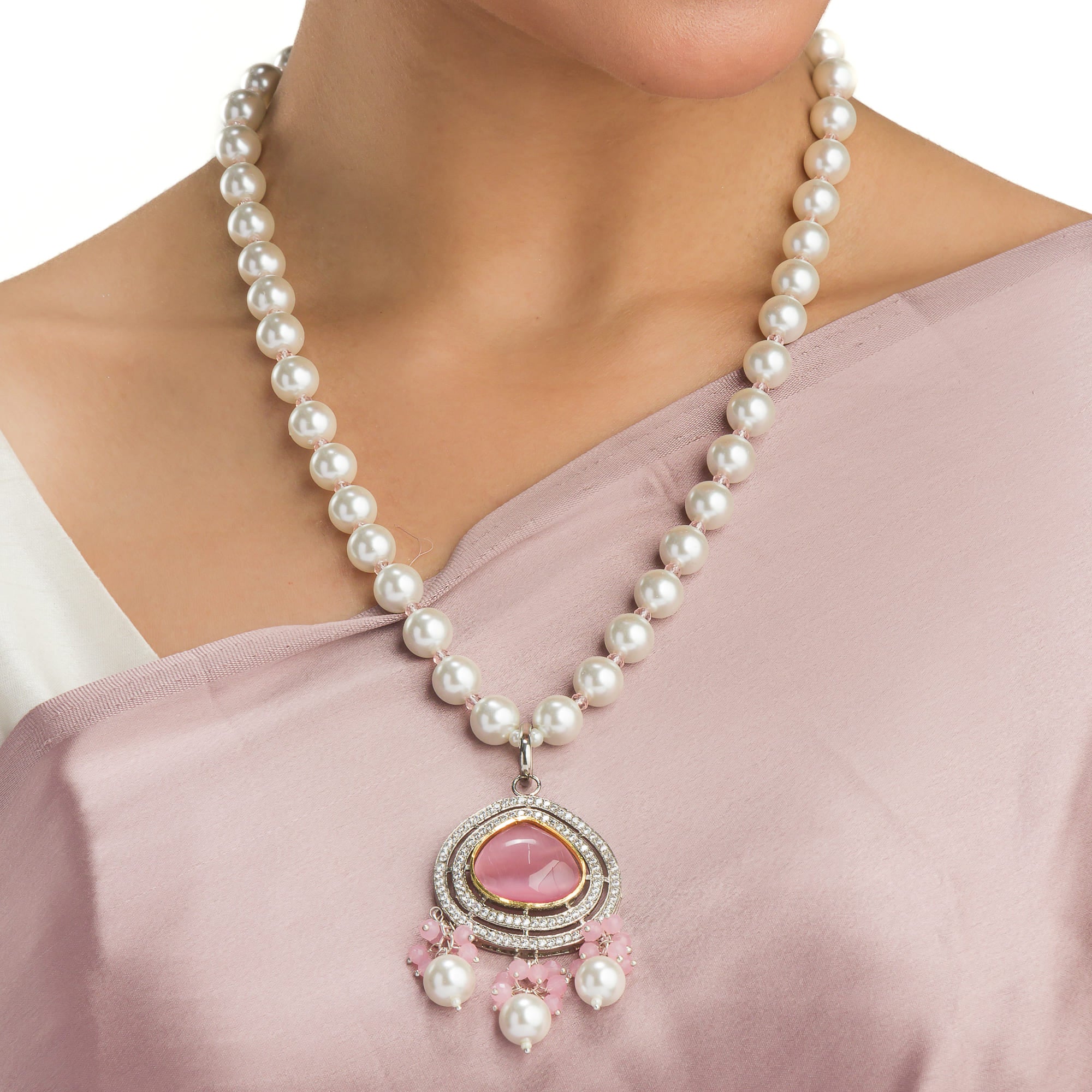"Graceful pink pendant on a white pearl long necklace for a feminine touch."
