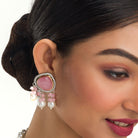 "Graceful pink pendant on a white pearl long necklace for a feminine touch."
