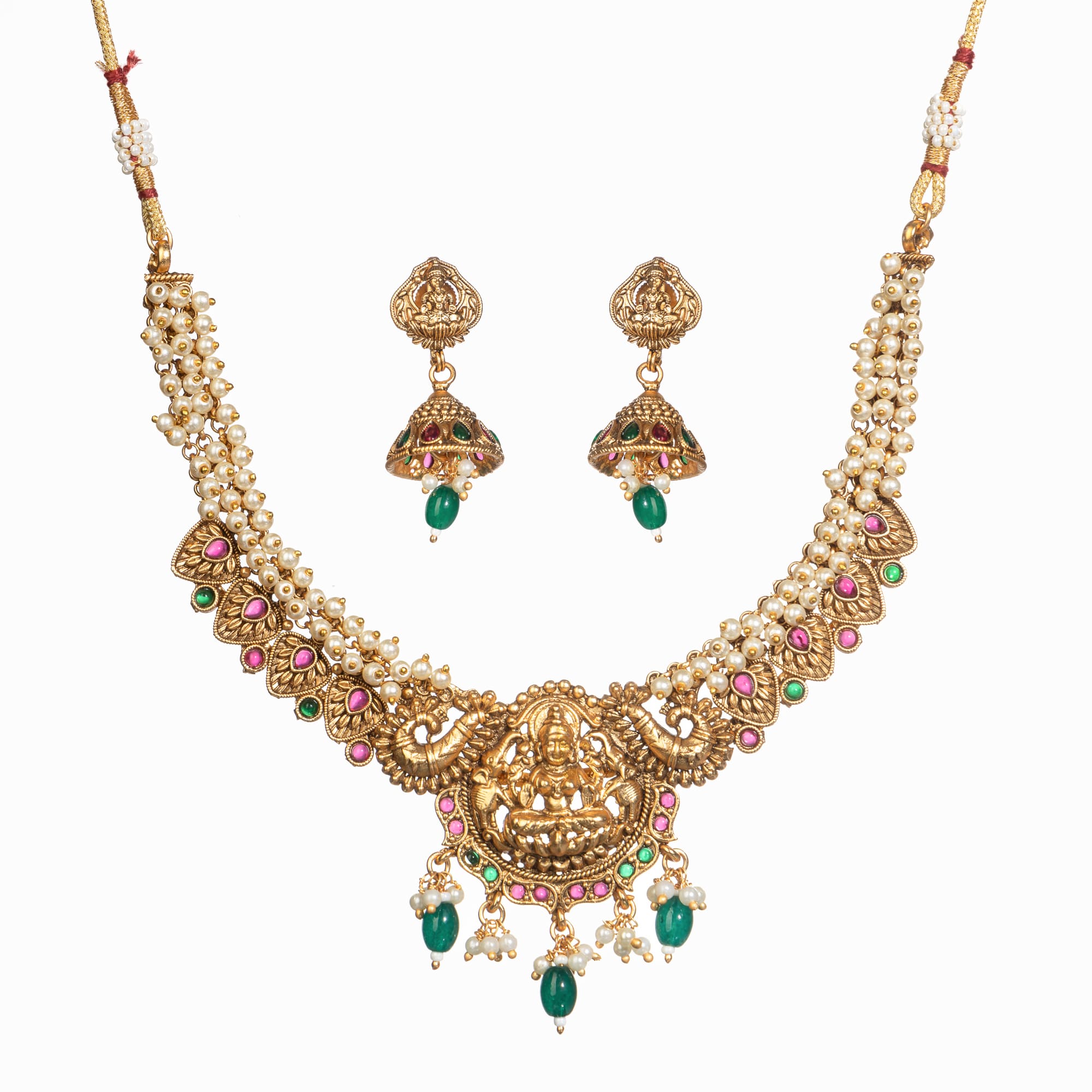 "Gold-tone necklace with white pearl and green Kundan for a timeless traditional look."
