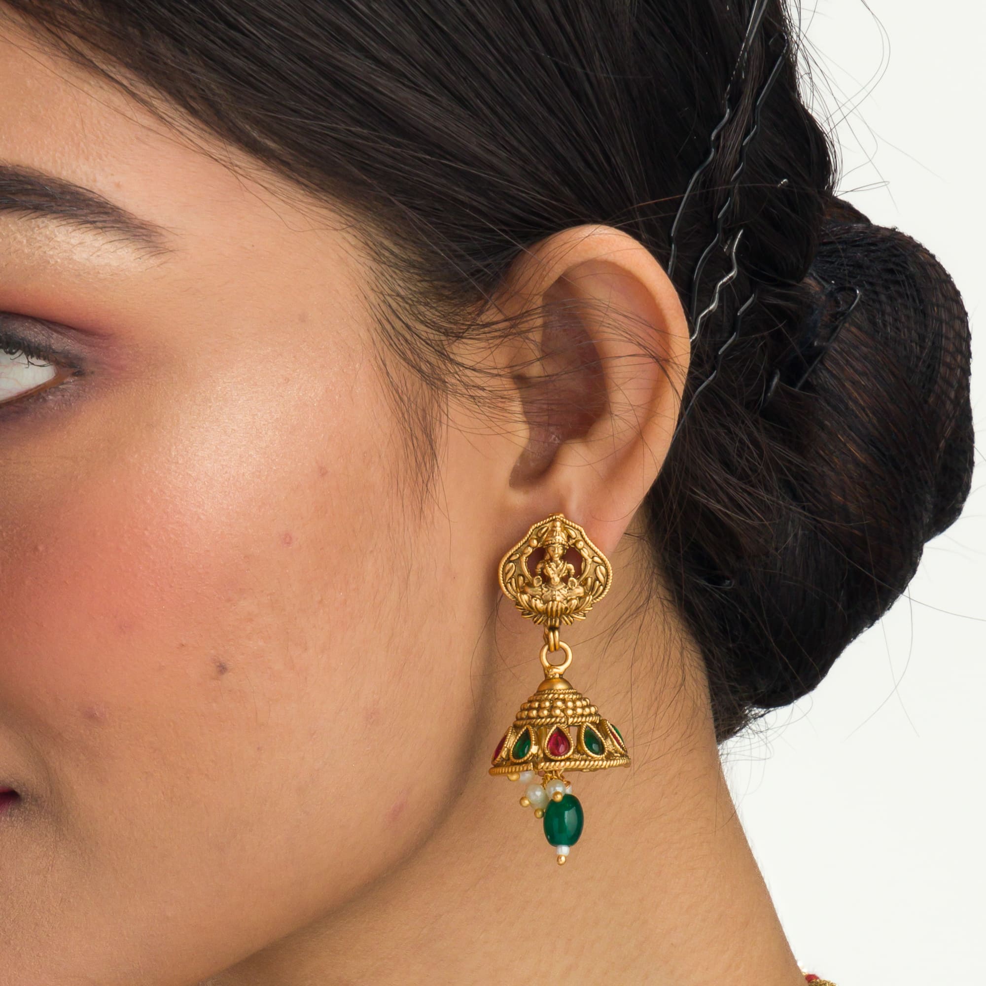 "Gold-tone necklace with white pearl and green Kundan for a timeless traditional look."
