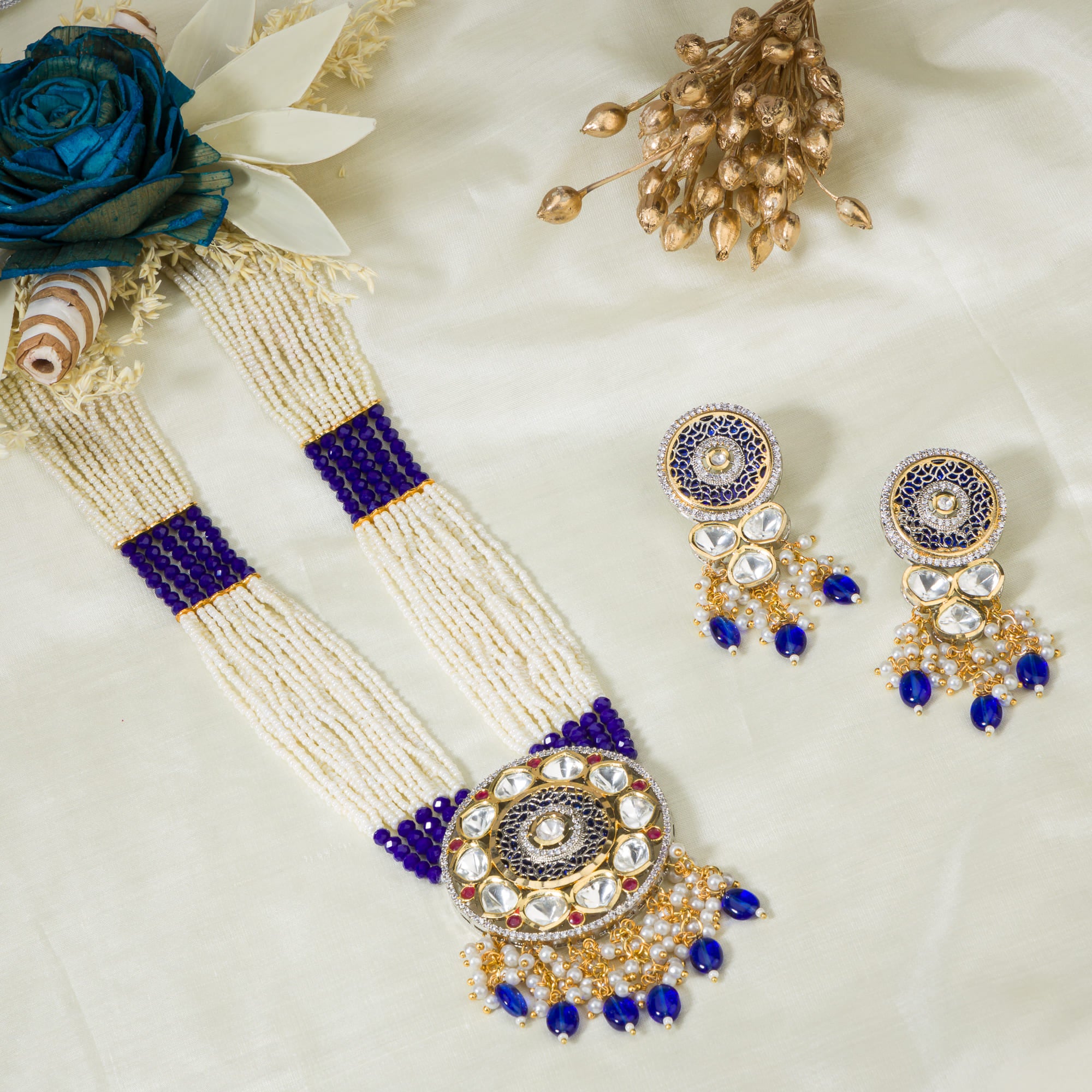 "Maharani long necklace with blue Kundan and white pearls for royal sophistication."
