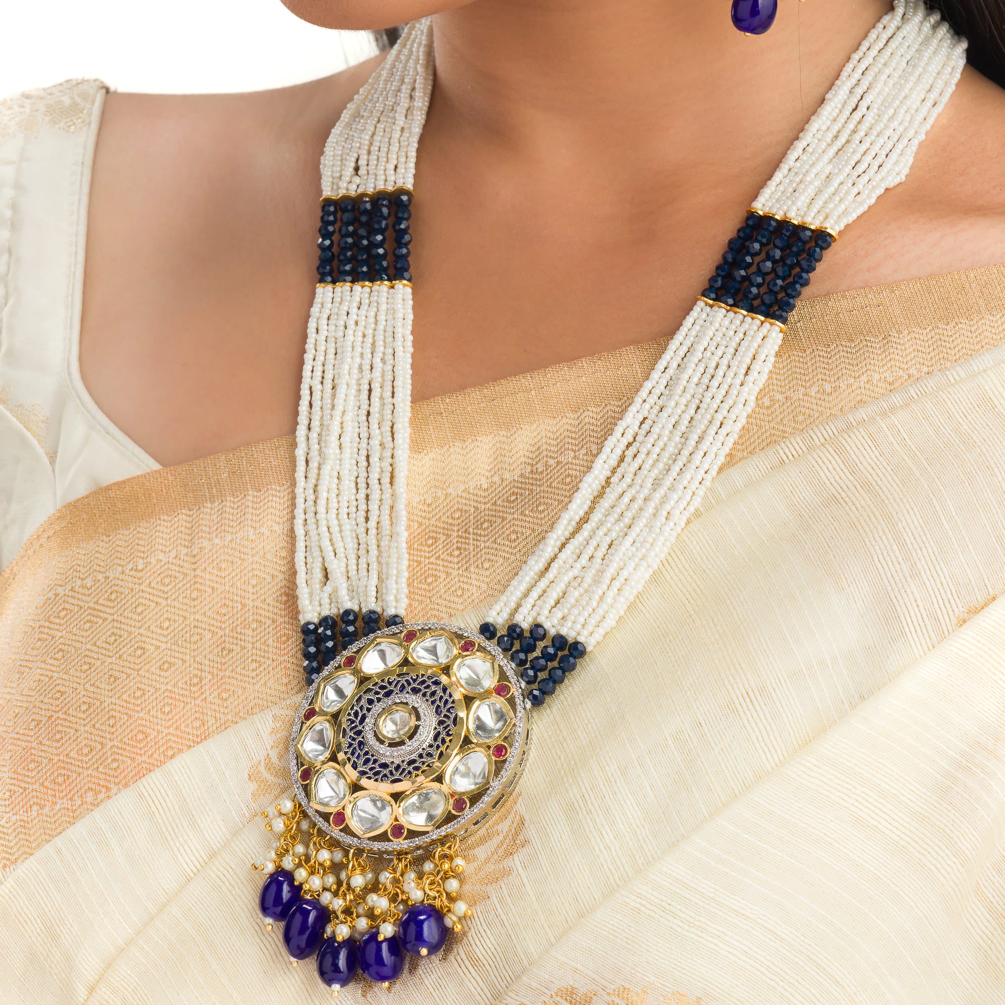 "Maharani long necklace with blue Kundan and white pearls for royal sophistication."
