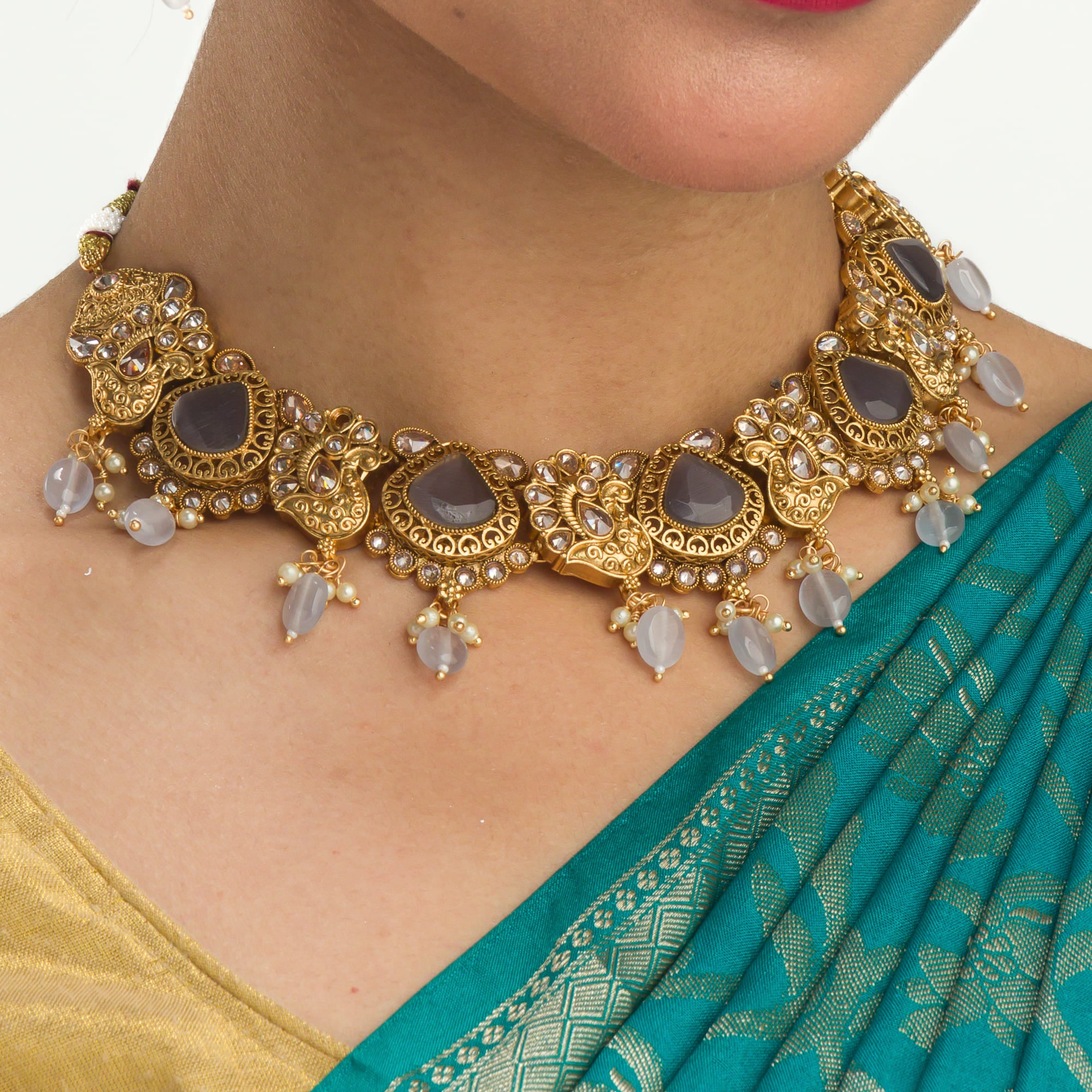 "Gold-tone necklace with grey stones and Kundan for a chic, modern appeal."

