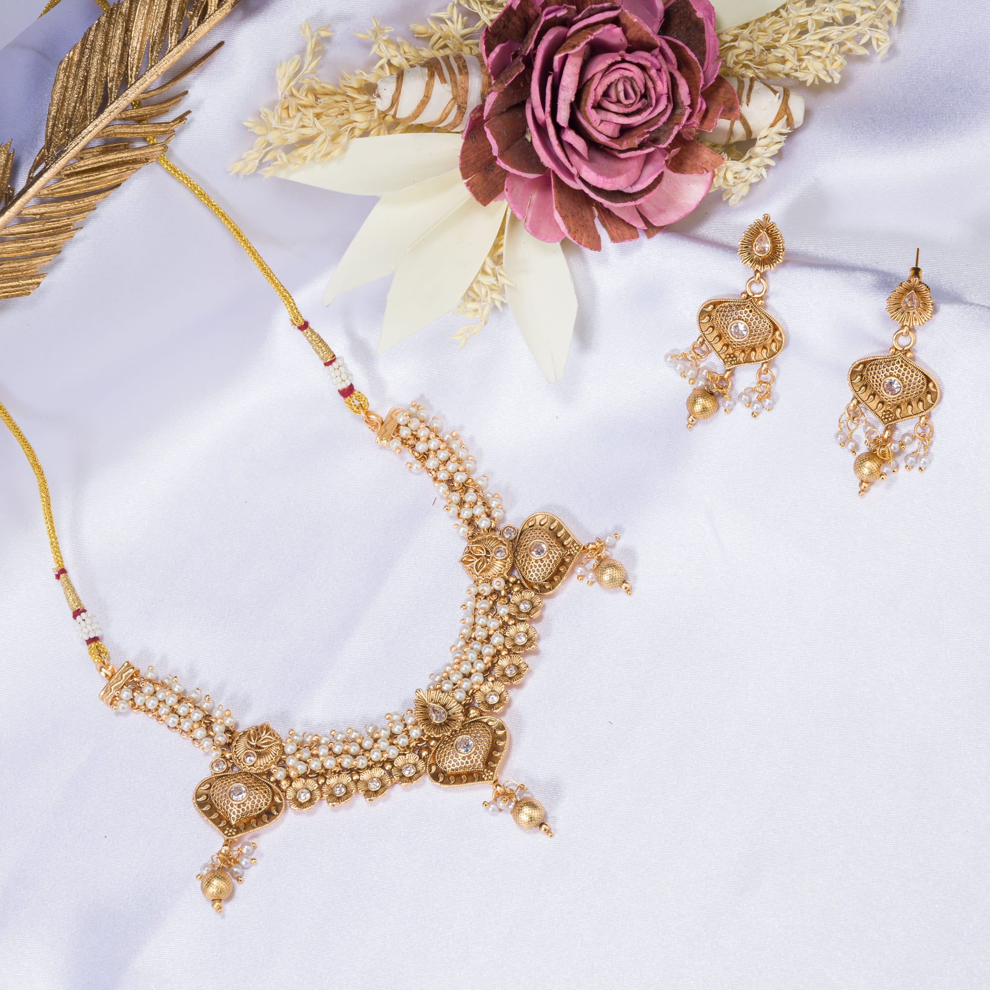 "Elegant goldtone necklace with lustrous pearls for timeless sophistication."
