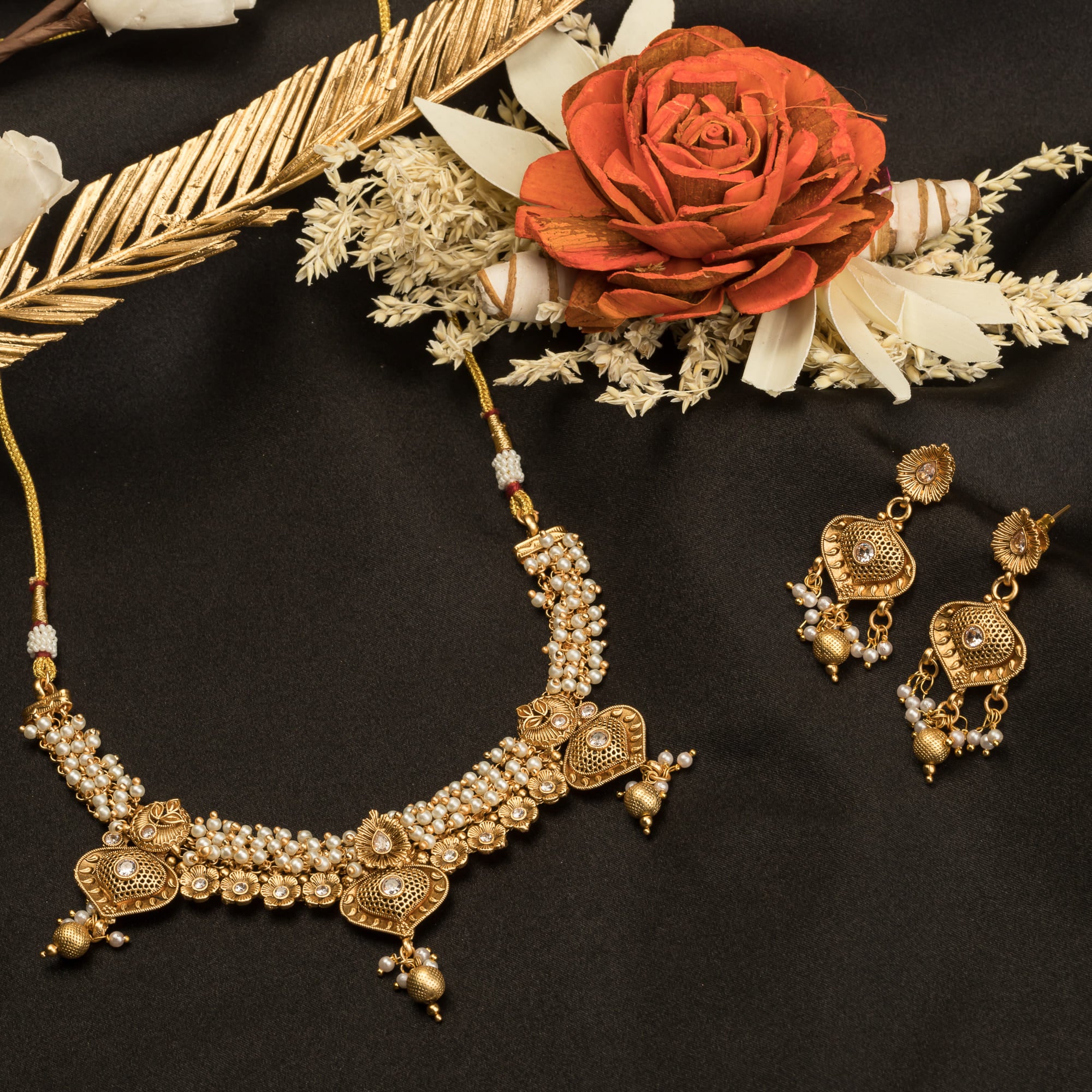 "Elegant goldtone necklace with lustrous pearls for timeless sophistication."
