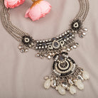 "Oxidized silver necklace with black and white beads adds stylish contrast."
