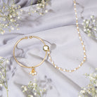 "Gold-polish nath with white pearls offers classic, elegant charm."
