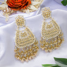 "Wheat-colored Kundan earrings make a bold, elegant statement."

