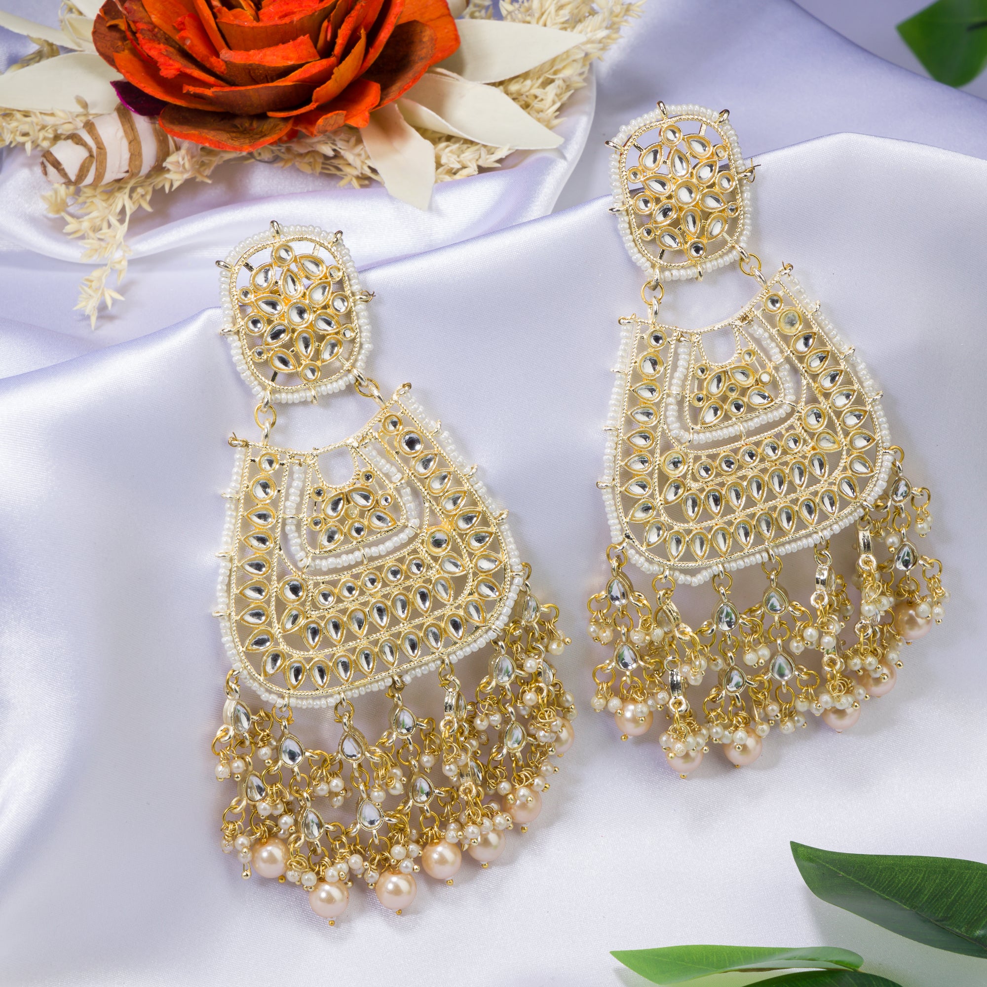 "Wheat-colored Kundan earrings make a bold, elegant statement."
