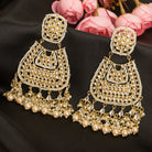 "Wheat-colored Kundan earrings make a bold, elegant statement."
