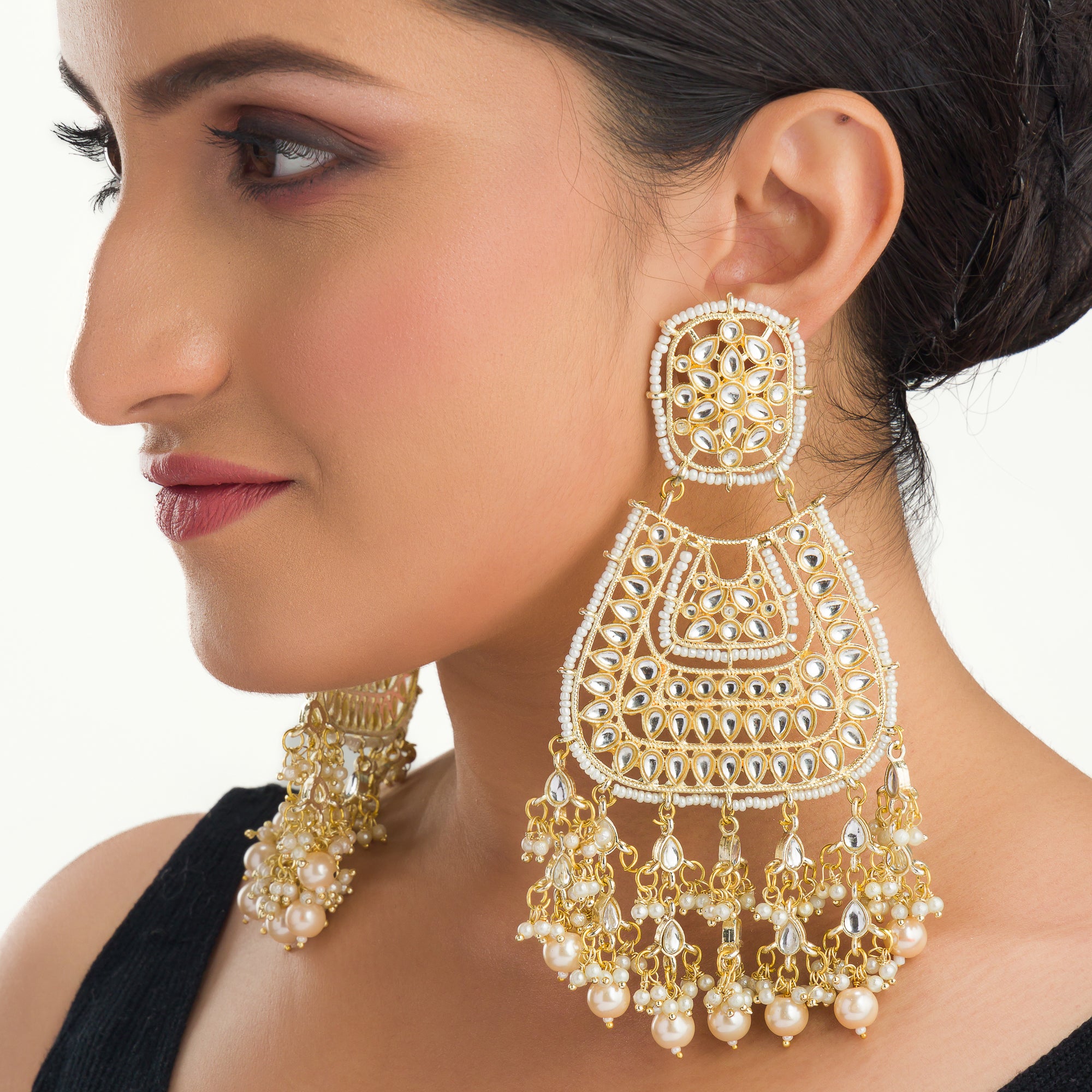 "Wheat-colored Kundan earrings make a bold, elegant statement."
